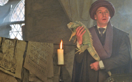Professor Quirrell is holding an Iguana in class