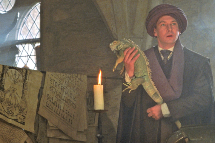 Professor Quirrell is holding an Iguana in class
